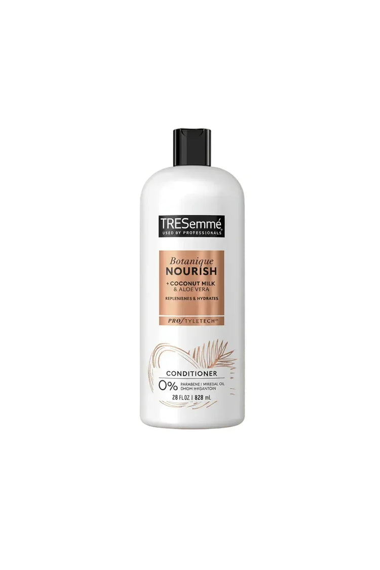 TRESemmé Botanical Nourish conditioner bottle on a decorative leaf and coconut background