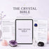 The Crystal Bible on a tablet with crystal stones and amethyst on a light background