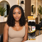 Model wearing black curly box braids with pre-made crochet style, shoulder length