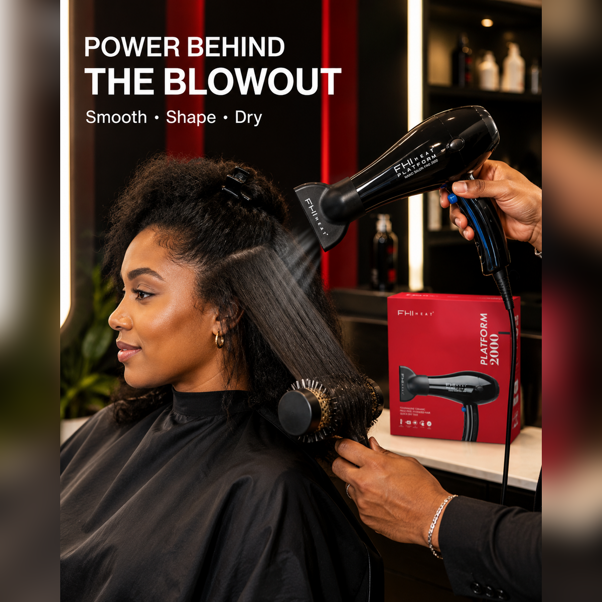 Black FHI Heat hair dryer being used, with box visible beside the dryer